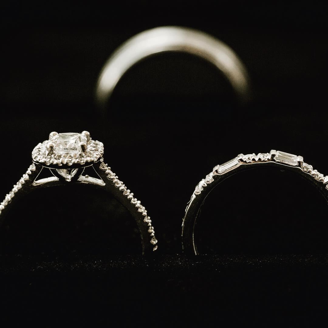 close up photo of wedding rings on black velvet