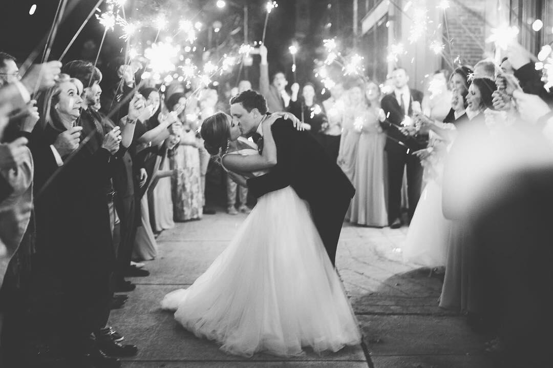black and white photos of couple dipping at sparkler exit of wedding reception