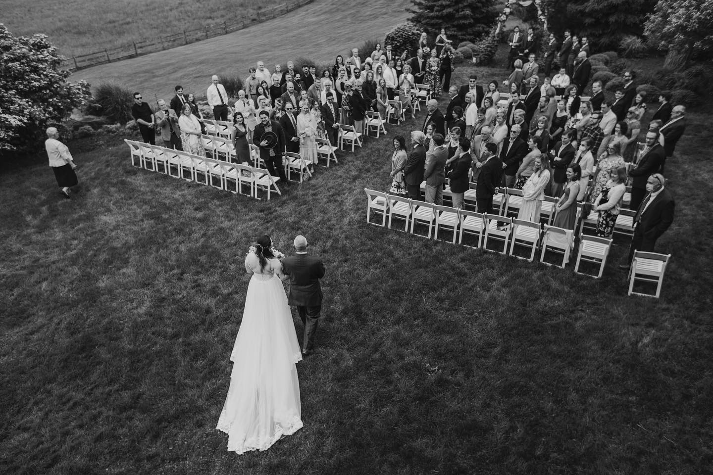 an aerial shot of the father of the bride walking the bride down the aisle