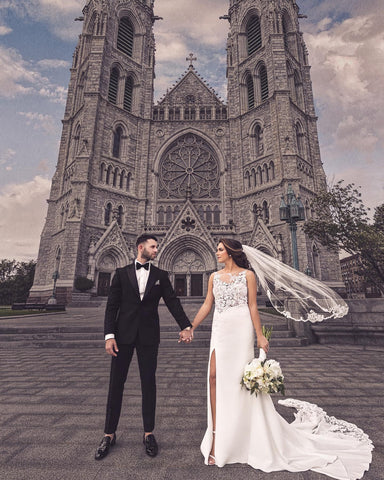 gothic cathedral with bride and groom holding hands in front 