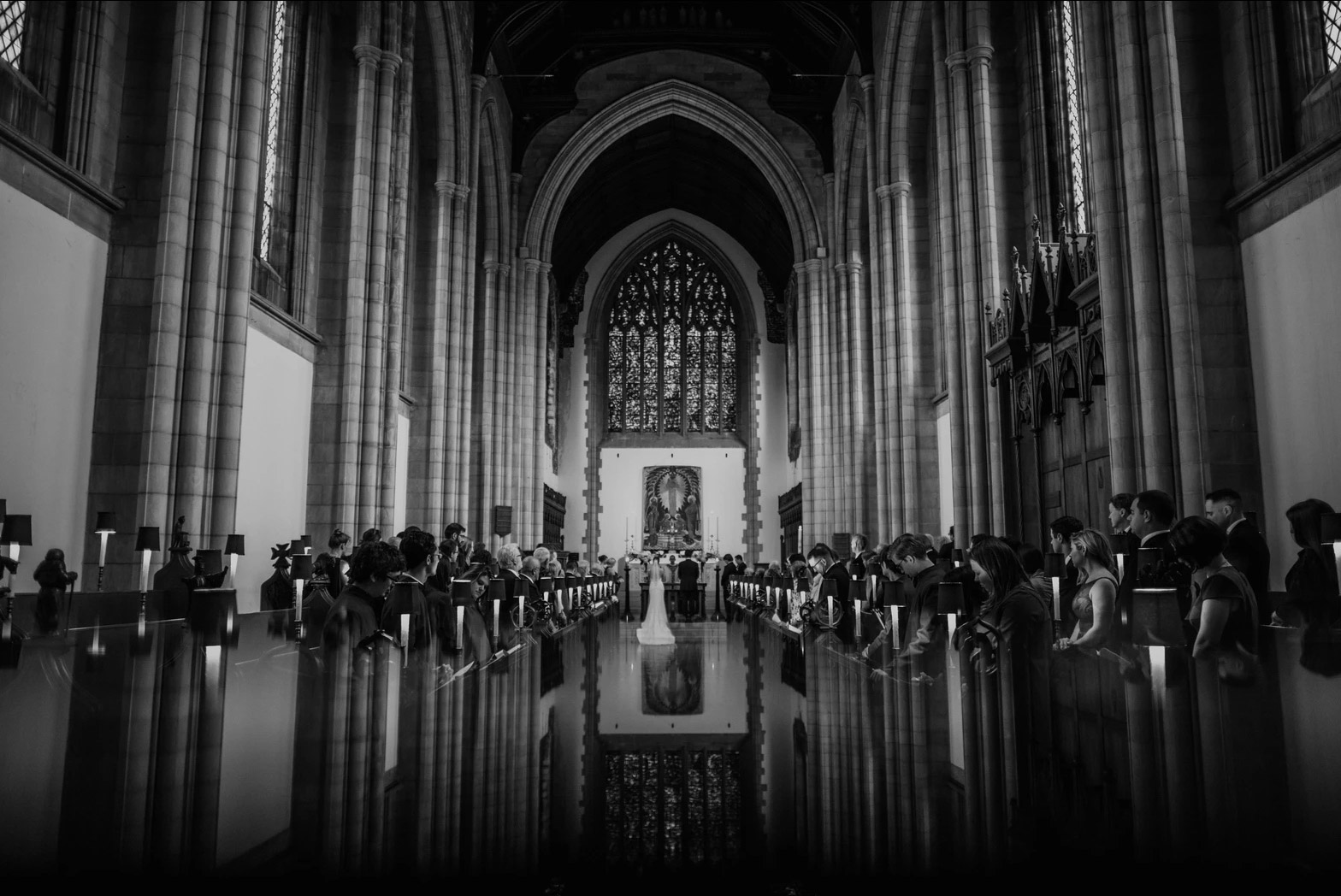 a wedding ceremony taking place in a grand cathedral