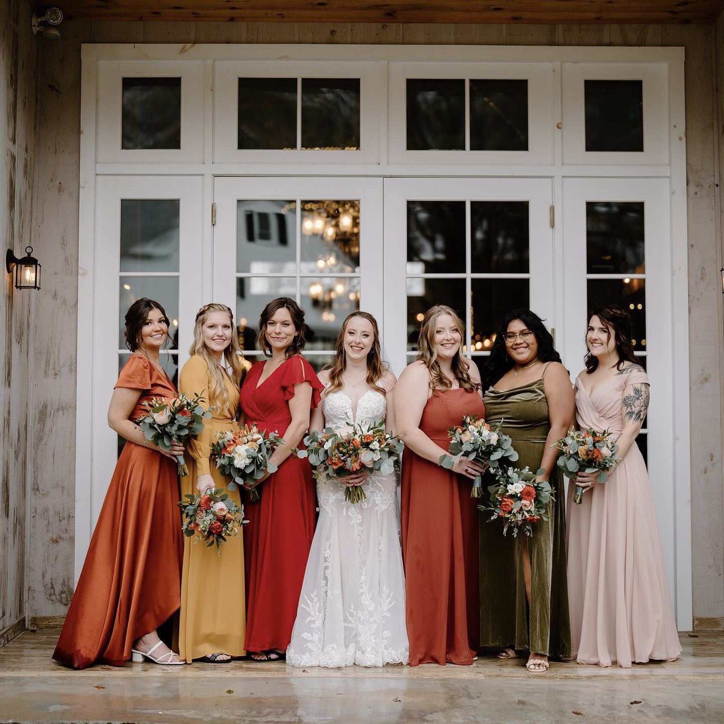a bride and her bridesmaids posing with their wedding bouquets