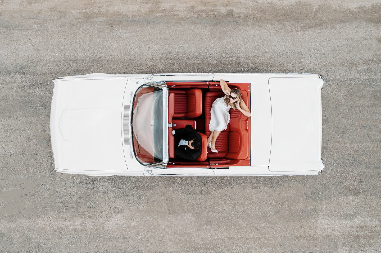 a top down shot of the bride and groom on the wedding car
