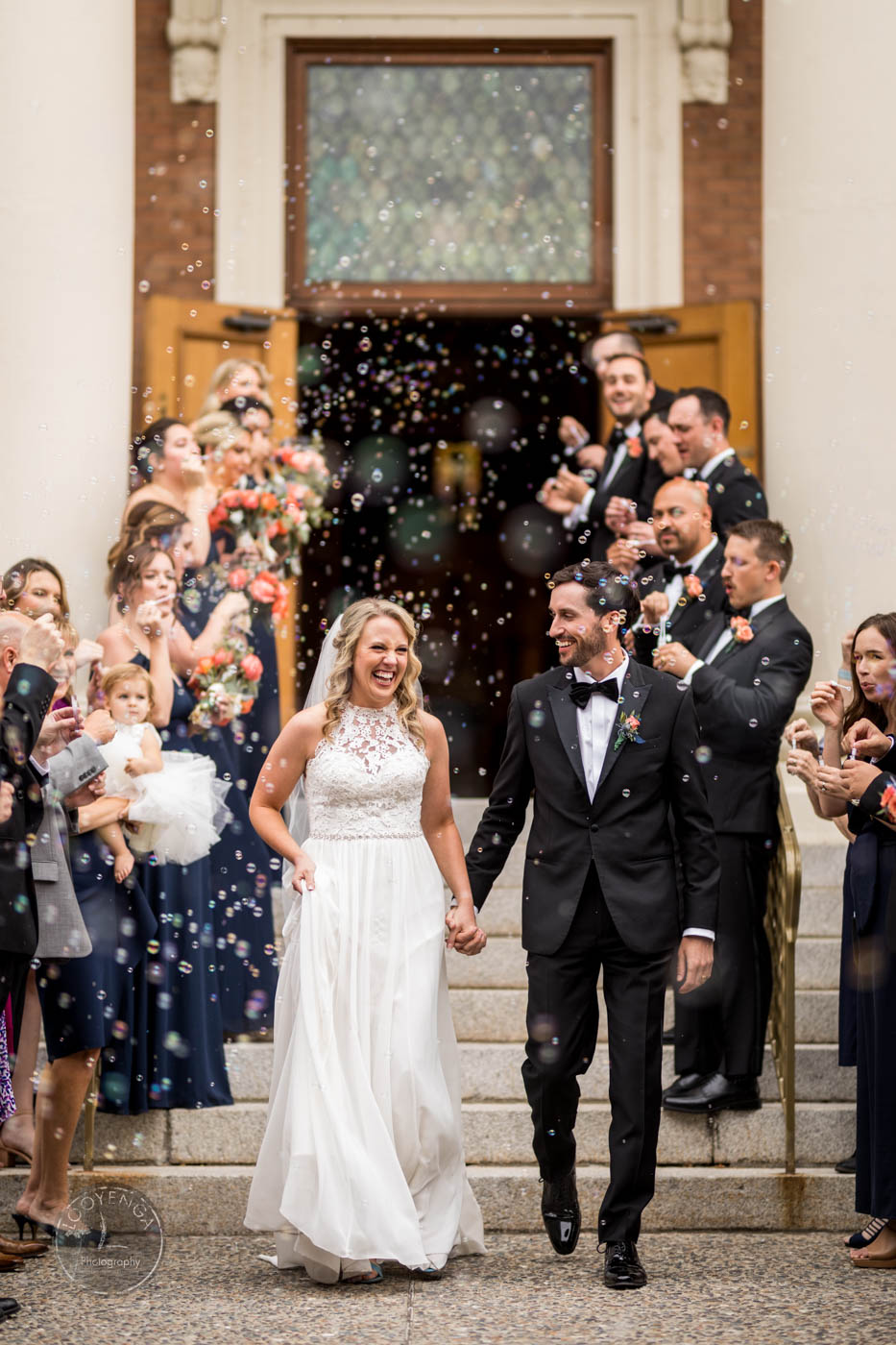 a wedding recessional following the wedding couple with a bubbles exit