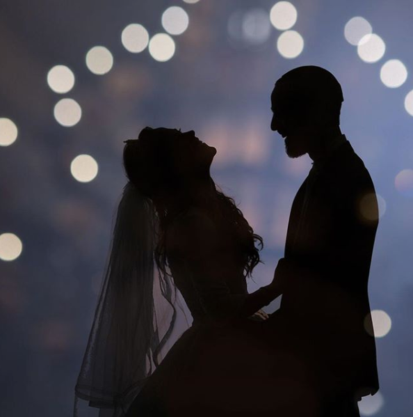 couple silhouetted with twinkle light and bokeh